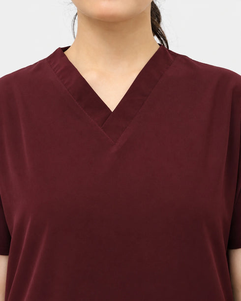 Close-up of the V-neck neckline on women's maroon medical scrubs