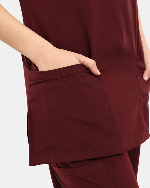 Close-up of the chest pocket on women's maroon scrub top